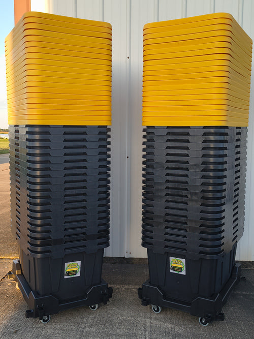 Two stacks of black totes with yellow lids on dollies